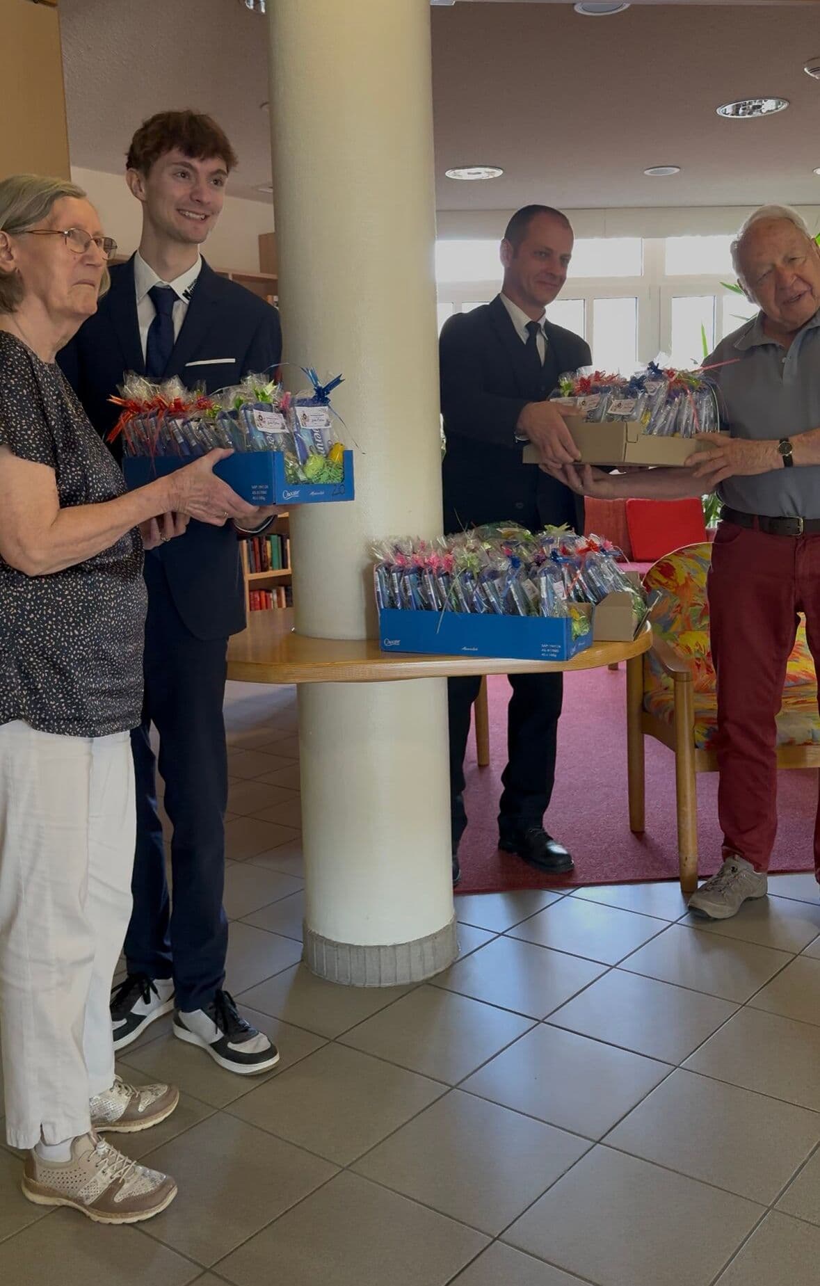ier Personen mit Geschenkboxen im Seniorenheim